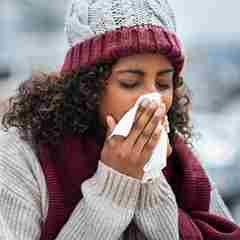 Woman With Cold Sneezing Outdoor