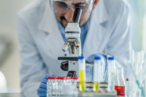 Medical Researcher Looking Through Telescope