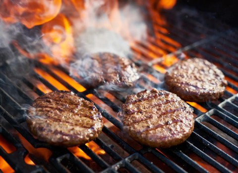 Cooked Burgers On A Grill.