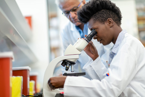 Medical Researcher Using Microscope