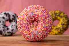 Doughnut With Sprinkles On Brown Wooden Table