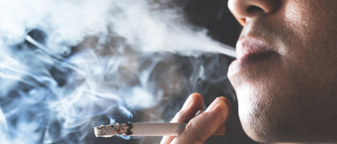 A Man Smoking A Cigarette