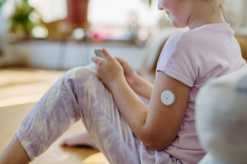 Person Sitting Down Using A CGM